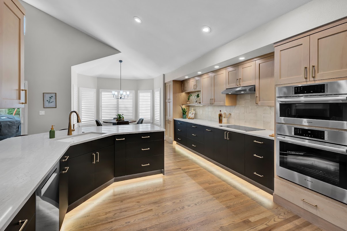 Finished kitchen and dining room with pendant, recessed, and cabinet lighting