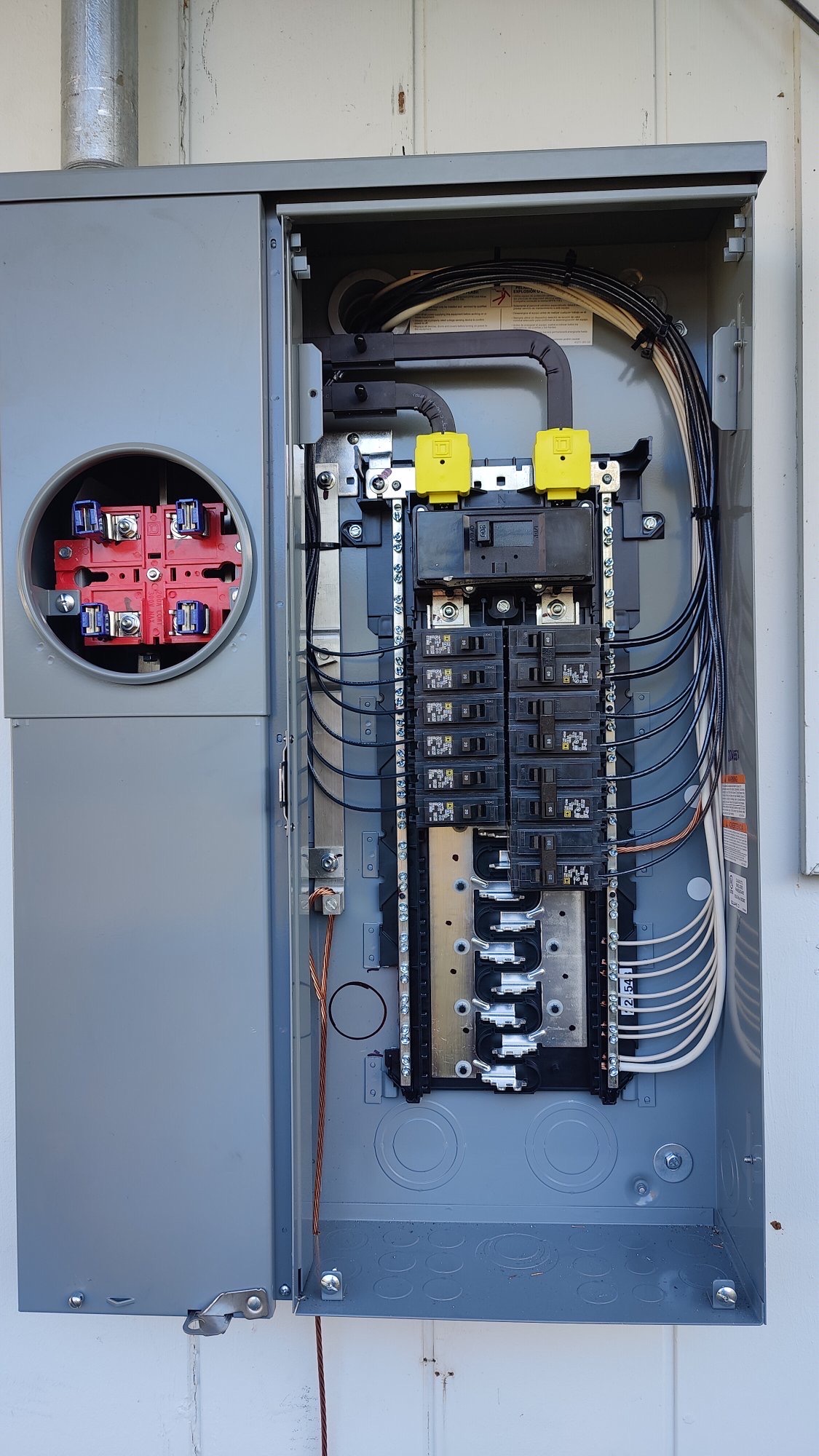 Newly installed 200-amp Square D meter main combo panel with neatly dressed branch circuits