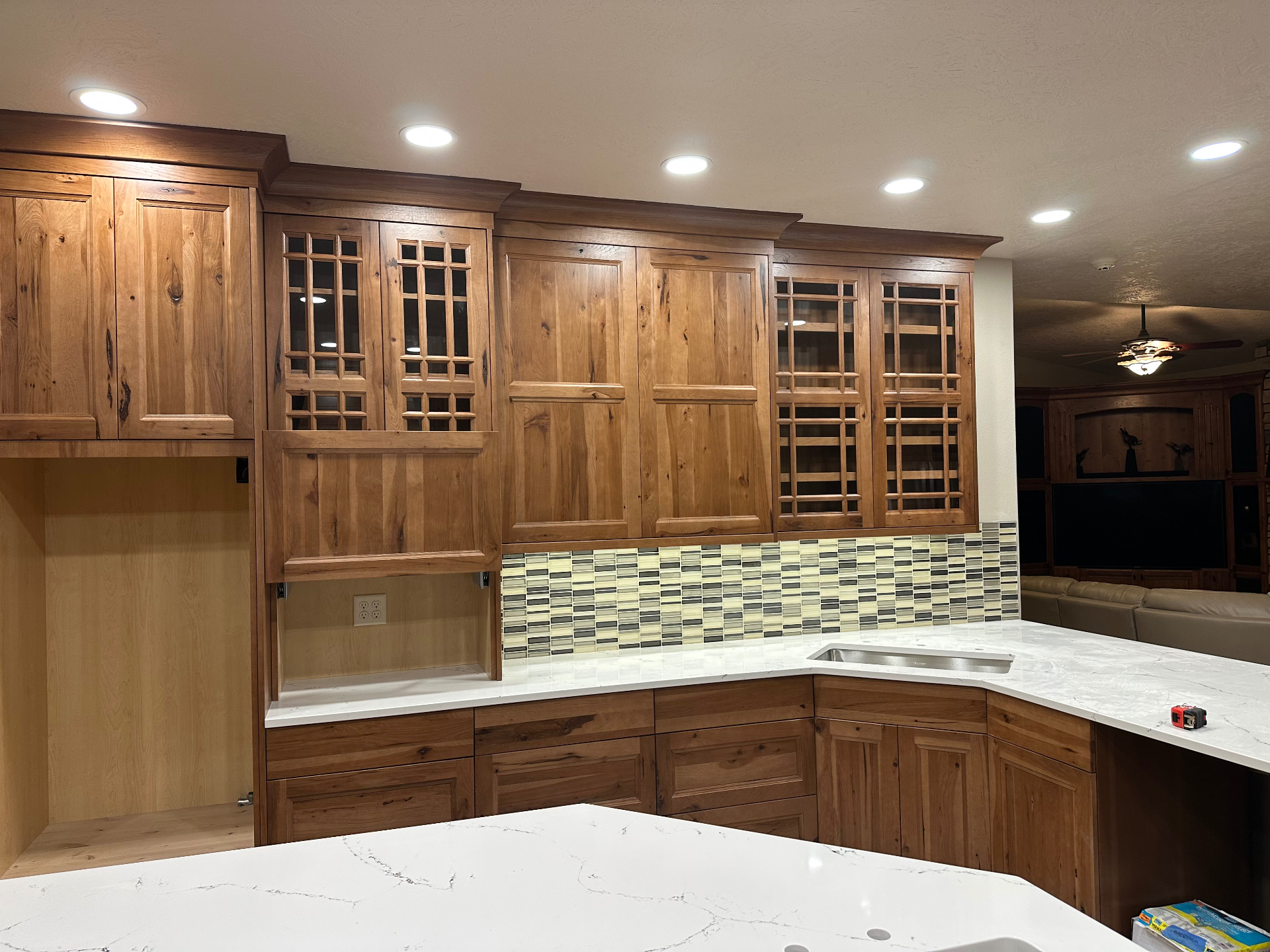Wood kitchen cabinetry with recessed lighting and under-cabinet illumination