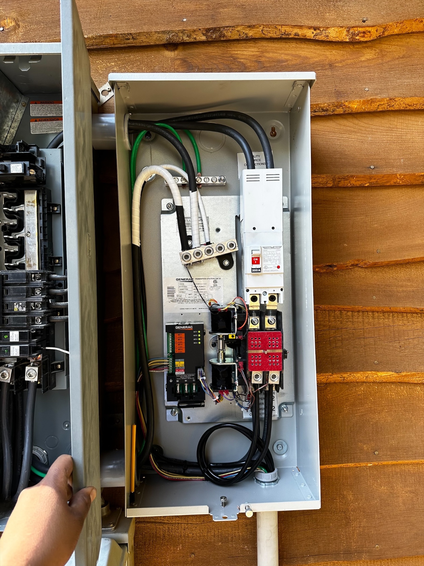 Generac automatic transfer switch with a 200-amp service breaker wired beside the main panel
