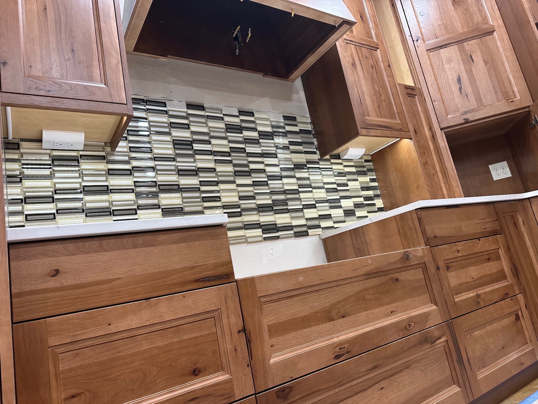 Unfinished kitchen cabinet area with visible wire awaiting a fixture install