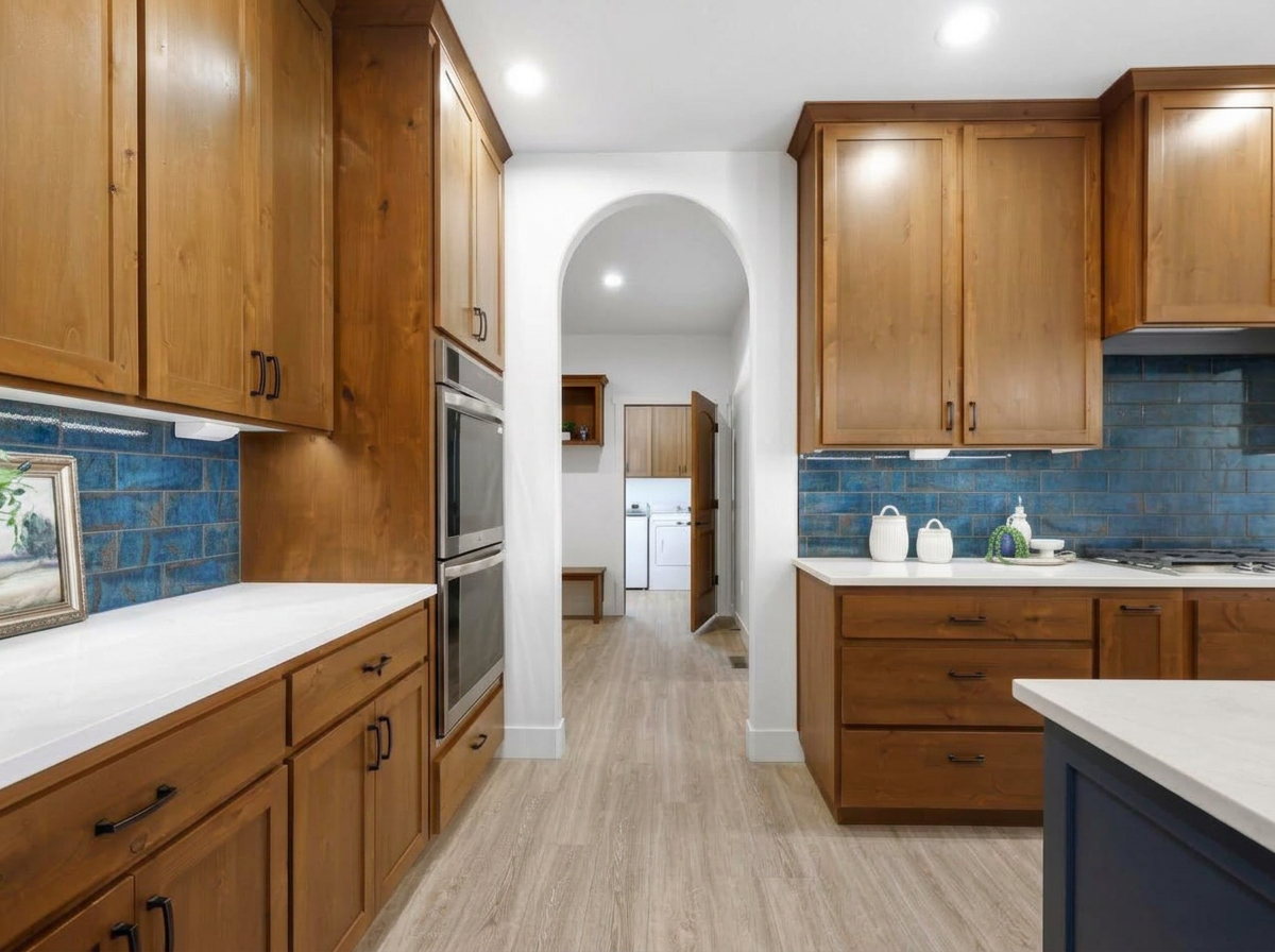Wood kitchen with blue tile backsplash and bright under-cabinet lighting